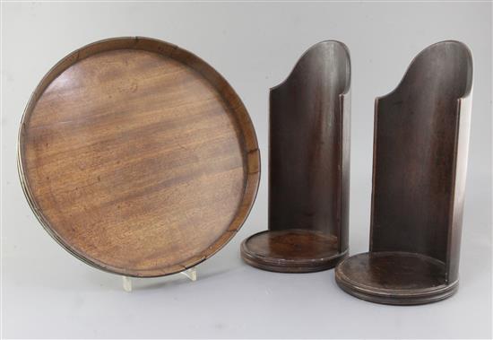 A pair of George III turned and carved mahogany candle shields, 11.5in., 12in.